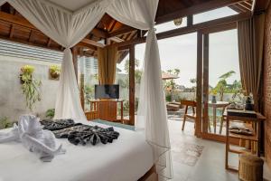 una camera da letto con un letto a baldacchino di Van Sheva Ubud Villa ad Ubud