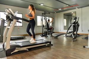 a woman on a treadmill in a gym at Jazzotel Bangkok in Bangkok
