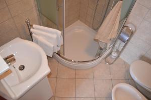 a bathroom with a shower and a toilet and a sink at Apartments Hedviga in Krk +21 photos