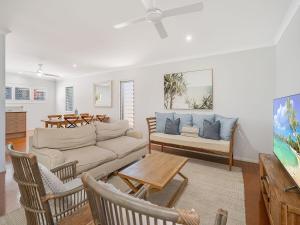 a living room with a couch and a table at Saltys Place, Pet Friendly and Close To Beach in Caloundra +7 photos
