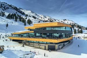 a building on top of a snow covered mountain at Apartment in Kaltenbach with Ski-In Ski-Out in Mühlfeld