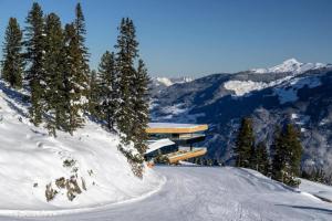 a building on top of a snow covered mountain at Apartment in Kaltenbach with Ski-In Ski-Out in Mühlfeld +4 photos