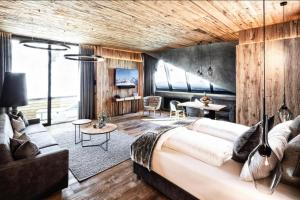 a bedroom with a large bed and a living room at Apartment in Kaltenbach with Ski-In Ski-Out in Mühlfeld