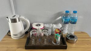 a tray with two bottles of water and a blender at Gypsy Village Resort in Phi Phi Islands