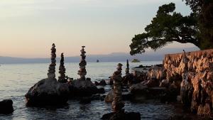 a group of towers on rocks in the water at Apartment Krizanovic in Malinska