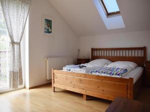 a bedroom with a wooden bed and a window at Holiday Home in Radstadt with Sauna & Whirlpool in Löbenau