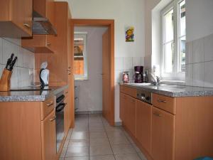 a kitchen with wooden cabinets and a counter top at Holiday Home in Radstadt with Sauna & Whirlpool in Löbenau