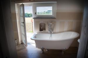 a white bath tub in a bathroom with a window at Don Carlo Agriturismo di Charme Bio in Le Pioppe +86 photos