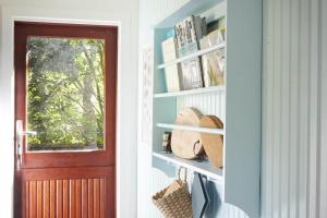 a room with a door and a shelf with books at 10000-1-Rorvig-Birkealle-2-A in Rørvig