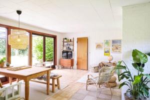 a living room with a wooden table and chairs at 10000-1-Rorvig-Birkealle-2-A in Rørvig