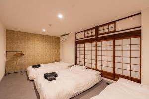 Giường trong phòng chung tại 春風荘 imazato