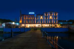 a building lit up at night with its lights on at Bacacan Otel in Ayvalık
