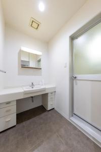 a bathroom with a sink and a large window at HITOYADO kanazawa in Kanazawa +41 photos
