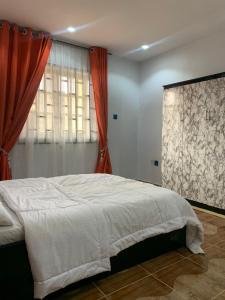 Postel nebo postele na pokoji v ubytování Royal palm Ijapo