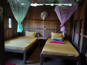 Ένα ή περισσότερα κρεβάτια σε δωμάτιο στο Ratanakiri Farmhouse & Trekking