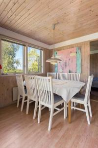 uma sala de jantar com uma mesa e cadeiras brancas em FJ2402-Skibby-Lindevaenget-50 em Rønø