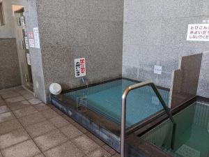 a pool of water in a bathroom with at glampark Verga in Hokuto