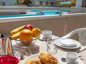 a table with a bowl of fruit and bread on it at Alba Adriatica apartments charm in Alba Adriatica