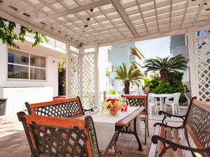 a patio with chairs and a table with fruit on it at Alba Adriatica apartments charm in Alba Adriatica