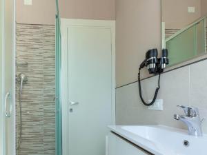 a bathroom with a shower and a sink and a phone at Alba Adriatica apartments charm in Alba Adriatica +31 photos