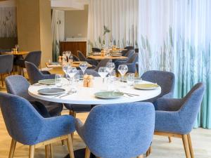a dining room with chairs and a table with wine glasses at ibis Styles Tours Centre in Tours