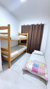 Ένα ή περισσότερα κρεβάτια σε δωμάτιο στο Casa completa em Praia Grande, 500 metros da praia