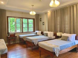 Ένα ή περισσότερα κρεβάτια σε δωμάτιο στο The Gather Inn Baguio - Burnham Park