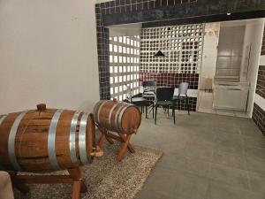 a room with a barrel and a table and chairs at Casa Praiana in Cabedelo
