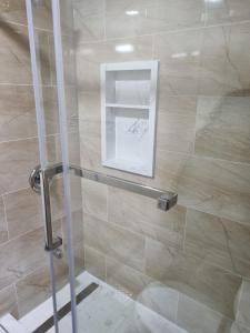 a shower with a glass door in a bathroom at Newly Renovated 3BR Upper Unit - Bright & Quiet in Richmond Hill