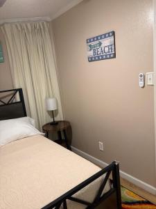 a bedroom with a bed and a sign on the wall at Seawall Breeze One bedroom Condo in Galveston in Galveston +18 photos