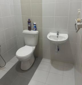 a bathroom with a toilet and a sink at NHI Home Paka in Paka +21 photos