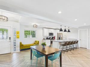 a kitchen and living room with a table and chairs at Sunhaven - Private Heated Pool - Walk to Old Town in Scottsdale