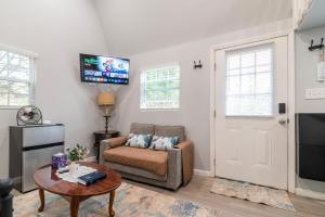 a living room with a couch and a tv at Tiny house with smart bidet and water purify-system in Gastonia