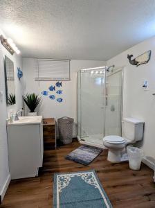 a bathroom with a shower and a toilet and a sink at By State Fair 5 bedrooms 2 baths in Des Moines