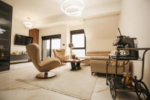 a living room with a chair and a couch at Grand Residence Zlatibor in Zlatibor