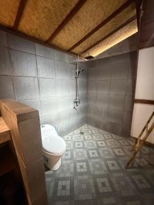 a bathroom with a toilet in a room at Villa Aiden Bungalow 2 near Beach in Ungasan