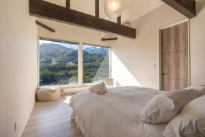 Postel nebo postele na pokoji v ubytování KIBEJE Hakuba by JAMSZ ROYALE