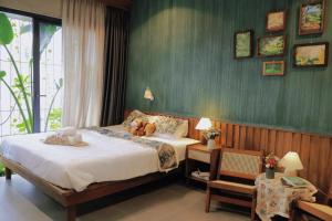 a bedroom with a bed with teddy bears on it at Soda Boutique Apartment Danang in Danang