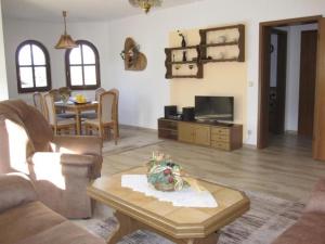 a living room with a couch and a table at Fehaus Johannesberg in Waltershausen