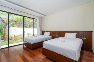 Ένα ή περισσότερα κρεβάτια σε δωμάτιο στο ESTUVILLA by Serenity +10 φωτογραφίες