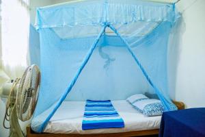 Ліжко або ліжка в номері Sagopearl Guest