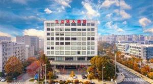 a large white building with red crosses on top of it at Hotel Leader Changsha in Changsha