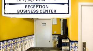 a building with a sign for a reception business center at Happy Family Hotel in Macau