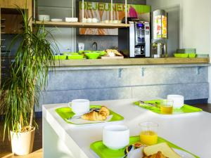 a kitchen with two plates of food on a counter at ibis budget Bordeaux Est Lormont in Lormont