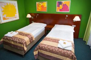 Postel nebo postele na pokoji v ubytování Hotel Rieger Garni