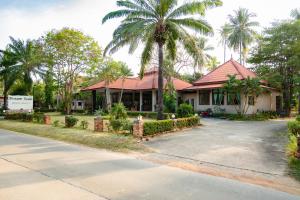 a house with a palm tree next to a street at Dream Team Beach Resort in Ko Lanta