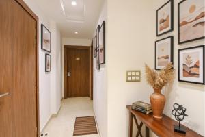 a hallway with a staircase with a vase on a table at FabHotel La Serene BnB- Ashok Vihar in New Delhi