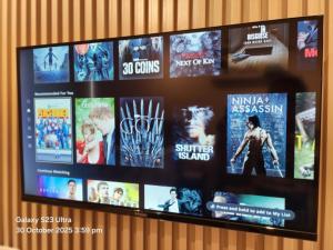 a tv screen with many different movies on it at Luna's Place in Sampong