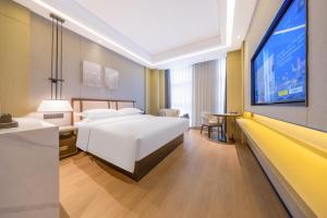 Postel nebo postele na pokoji v ubytování 云颐自在酒店鄂尔多斯东胜区全民健身中心店 + 11 fotografií