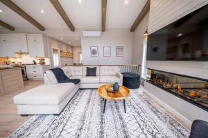 a living room with a couch and a fireplace at Ski in - Ski out - SPA & Pool Table - Le Konect in Saint-Philémon